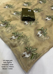 Beige organza embroidery saree.